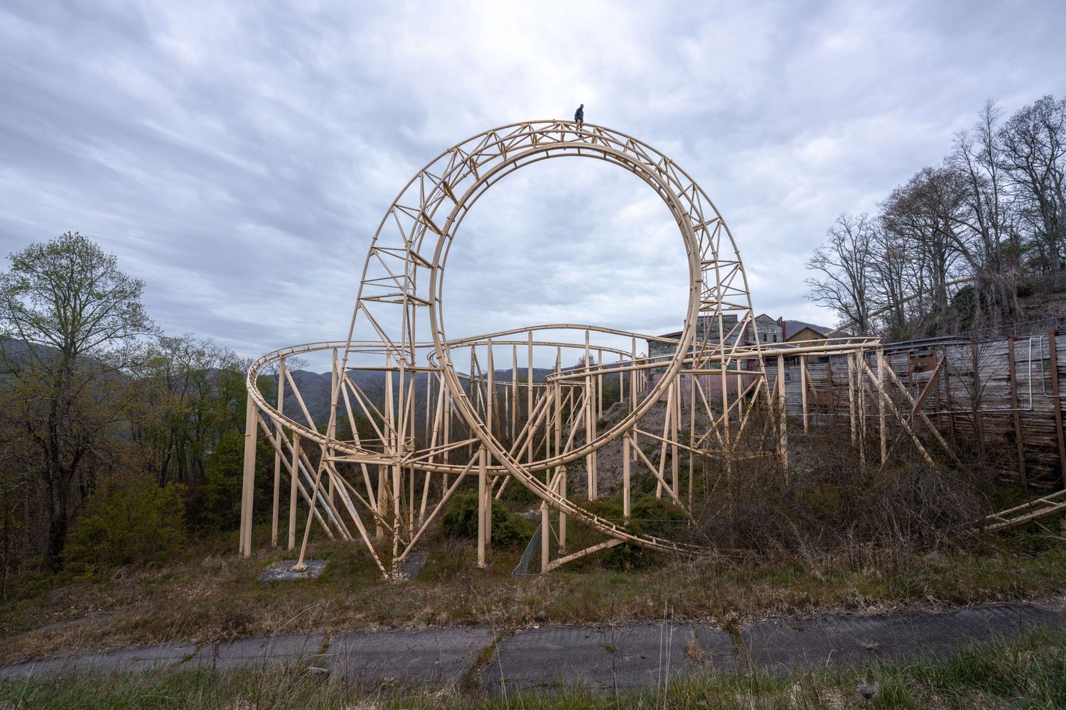 Ryan Garb standing on top of an abandoned roller coaster loop
